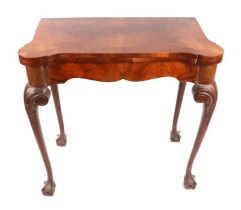 A Queen Anne style walnut card table with carved acanthus leaf cabriole legs, on ball & claw feet,