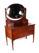 An Edwardian inlaid mahogany dressing chest, the oval mirror above two short jewellery drawers