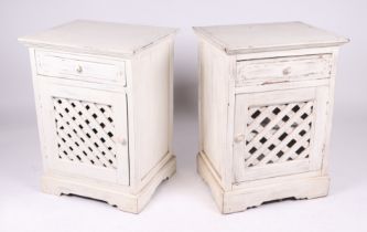 A pair of distressed painted bedside cupboards with single frieze drawer and cupboard beneath, 53 by