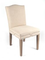 An OKA chair with upholstered seat and back, on square tapering supports.