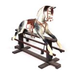 A large late 19th / early 20th century dapple grey safety rocking horse with leather saddle and