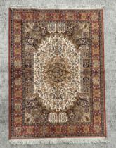 A silk and cotton rug, the central medallion within a multi floral border, 170 by 123cms.