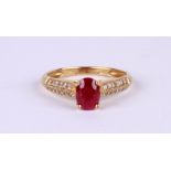 A 9ct gold dress ring set with an oval ruby and diamond set shoulders, approx UK size 'O', 2g.