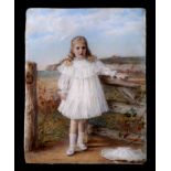 An early 20th century portrait miniature on ivorine depicting a young girl standing by a gate,