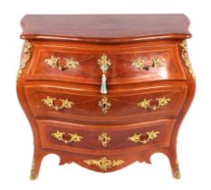 A continental bombe commode with three long drawers and ormolu mounts, 90cms wide.