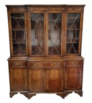 A Georgian style breakfront bookcase on cupboard, with four astragal glazed doors enclosing a