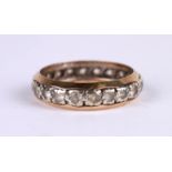 A 9ct gold eternity ring set with white stones (possibly white sapphire), approx UK size 'M', 2.7g.