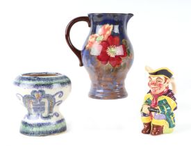 A Royal Doulton jug decorated with flowers, 21cms high; together with a Wade character jug