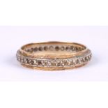 A yellow metal eternity ring set with white stones, approx UK size 'Q', 2.1g.