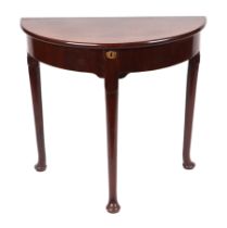 A Georgian mahogany demi lune side table with lift-up top, on turned legs and pad feet, 77cms wide.
