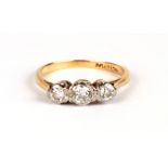 An 18ct gold & platinum three-stone diamond ring, approx UK size 'M', 2.5g.