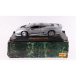 A Maisto 1:12 scale Jaguar XJ220 diecast model mounted on a plinth, boxed.