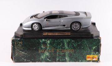 A Maisto 1:12 scale Jaguar XJ220 diecast model mounted on a plinth, boxed.