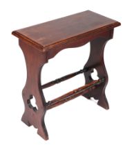 An oak Arts & Crafts style stool with shaped and pierced end supports joined by pole stretchers,