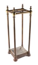 A cast iron and brass four-division stick stand, 23cms wide.