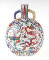 A Chinese Wucai style moon flask decorated with dragons and phoenix amongst clouds, 27cms high.