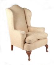 A George III style upholstered wingback armchair.