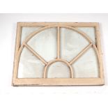 Architectural savage: A wooden arched over doorway window, 92 by 70cms.