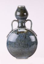 A Chinese mottled blue glaze two-handled vase, 27cms high.