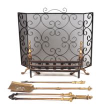 A Georgian style cast iron and brass fire grate; together with a set of brass fire irons and a