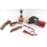 A quantity of assorted militaria to include a WWII gas mask, an inert hand grenade converted into