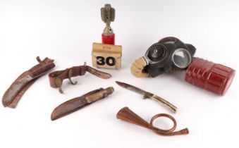 A quantity of assorted militaria to include a WWII gas mask, an inert hand grenade converted into