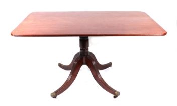 A Victorian mahogany breakfast table, the rounded rectangular top with ebony stringing, on a