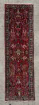 A Persian hand knotted runner with stylised floral design, on a beige ground, 280 by 78cms (61/19).