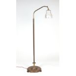 A Victorian style brass rise-and-fall standard lamp with glass shade.