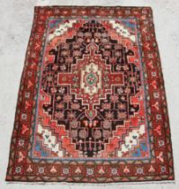 A Persian Hamadan rug with geometric design, on a beige ground, 210 by 140cms.