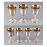 A set of seven mid century silver goblets with bell shaped bowls, vase shaped stems and spreading