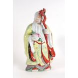 A Chinese figure of Shoulau holding a peach and a staff, 46cms high.