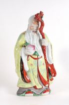 A Chinese figure of Shoulau holding a peach and a staff, 46cms high.