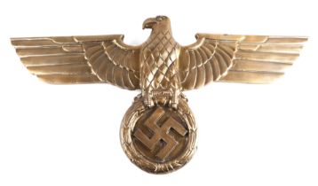 A modern cast metal Third Reich style eagle plaque, 102cms wide.