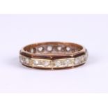A 9ct gold eternity ring set with white stones (possibly white sapphire), approx UK size 'M', 2.6g.
