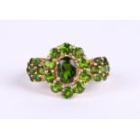 A 9ct gold triple cluster dress ring set with bright green stones, approx UK size 'N', 3.6g.