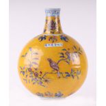 A Chinese bottle vase of compressed globular form decorated with birds amongst flowering foliage