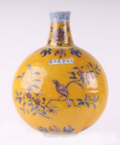 A Chinese bottle vase of compressed globular form decorated with birds amongst flowering foliage