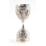 An Indian white metal double ended spirit measure with two bands of repousse decoration, 83g,