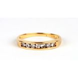 An 18ct gold seven stone diamond ring, approx UK size 'N', 2.6g.