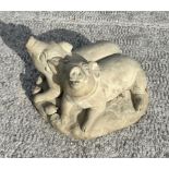 A reconstituted stone recumbent pig and piglets, 50cms wide; together with another similar garden