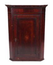 A 19th century oak hanging corner cupboard with single panelled door with shell inlay, 74cms wide.