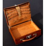 An early 20th century crocodile leather stationery box with fitted watered silk interior, the lid