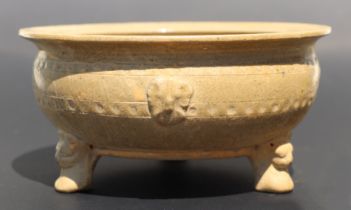 A Chinese monochrome brown glaze tripod footed bowl with incised decoration, 20cm diameter.