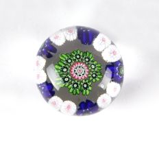 A miniature Clichy paperweight with floral canes, approx 4.5cms diameter. Condition Report In good
