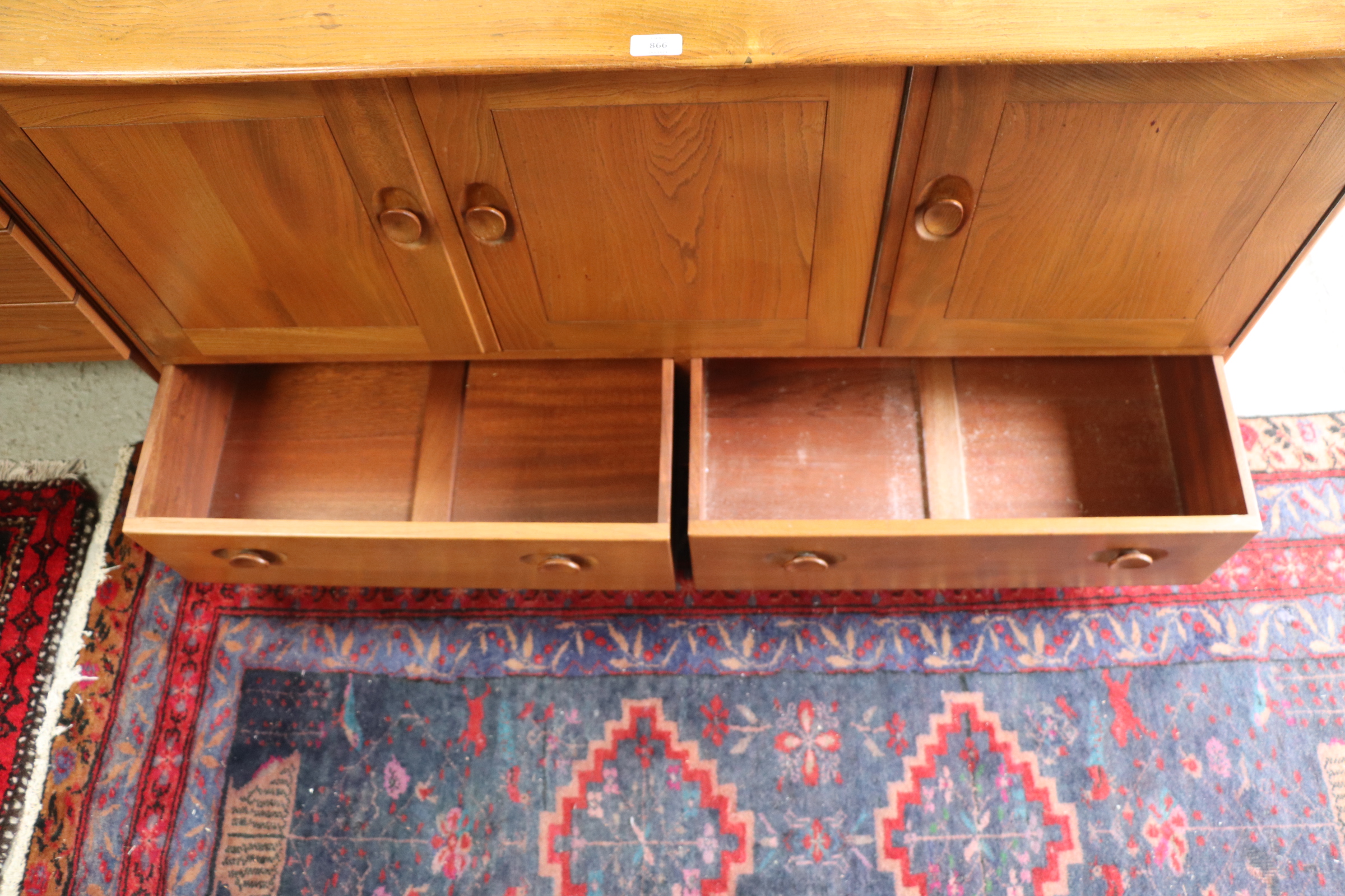 An Ercol sideboard with three cupboards above two long drawers, 131cms wide. Condition Report The - Image 9 of 9