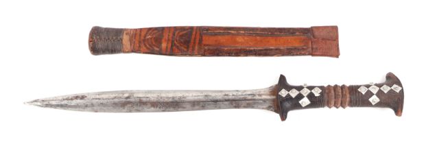 A North African dagger with hardwood handle and leather sheath.