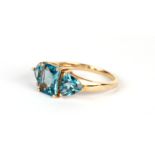 A 9ct gold dress ring set with three large pale blue stones, possibly aquamarine, approx UK size '