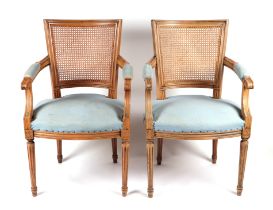 A pair of French chairs with upholstered seat and caned backs