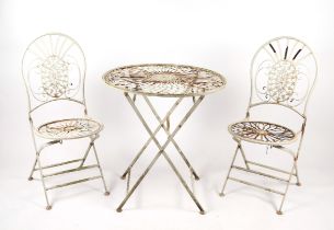 A French style three piece painted metal patio set comprising a table, 70cms diameter, and two